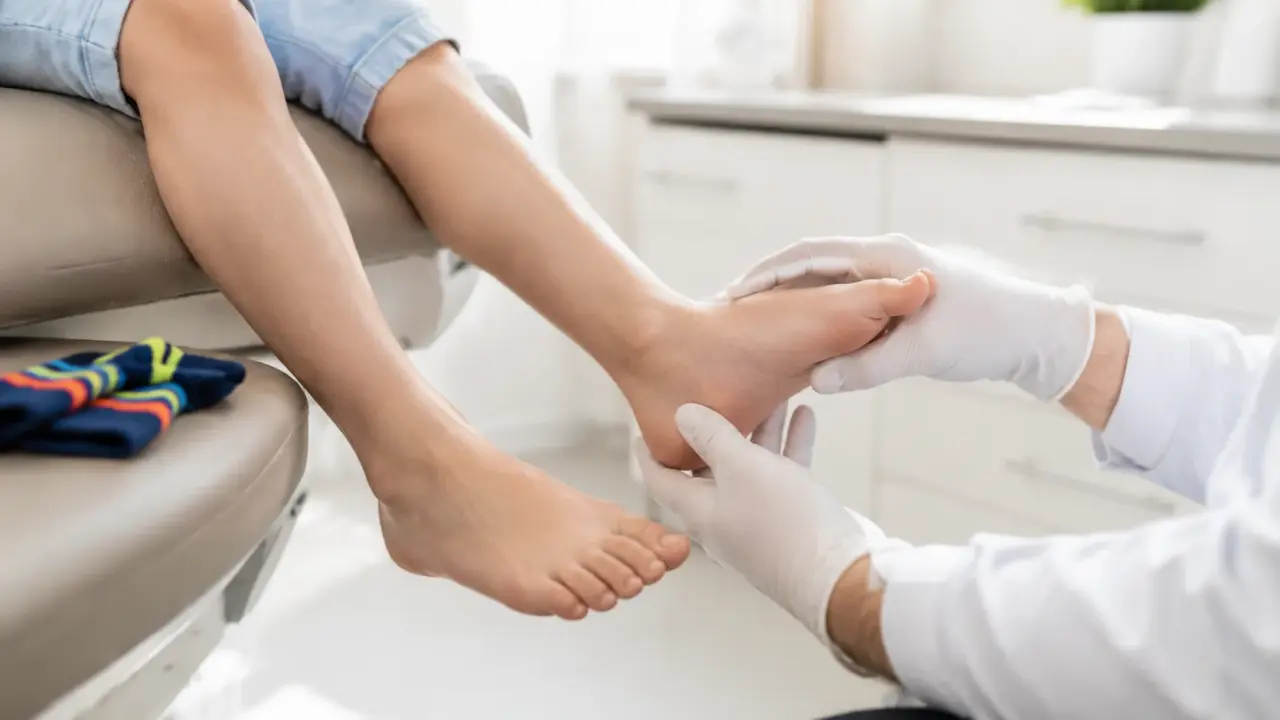 Podiatrist examining a child foot during a paediatric appointment